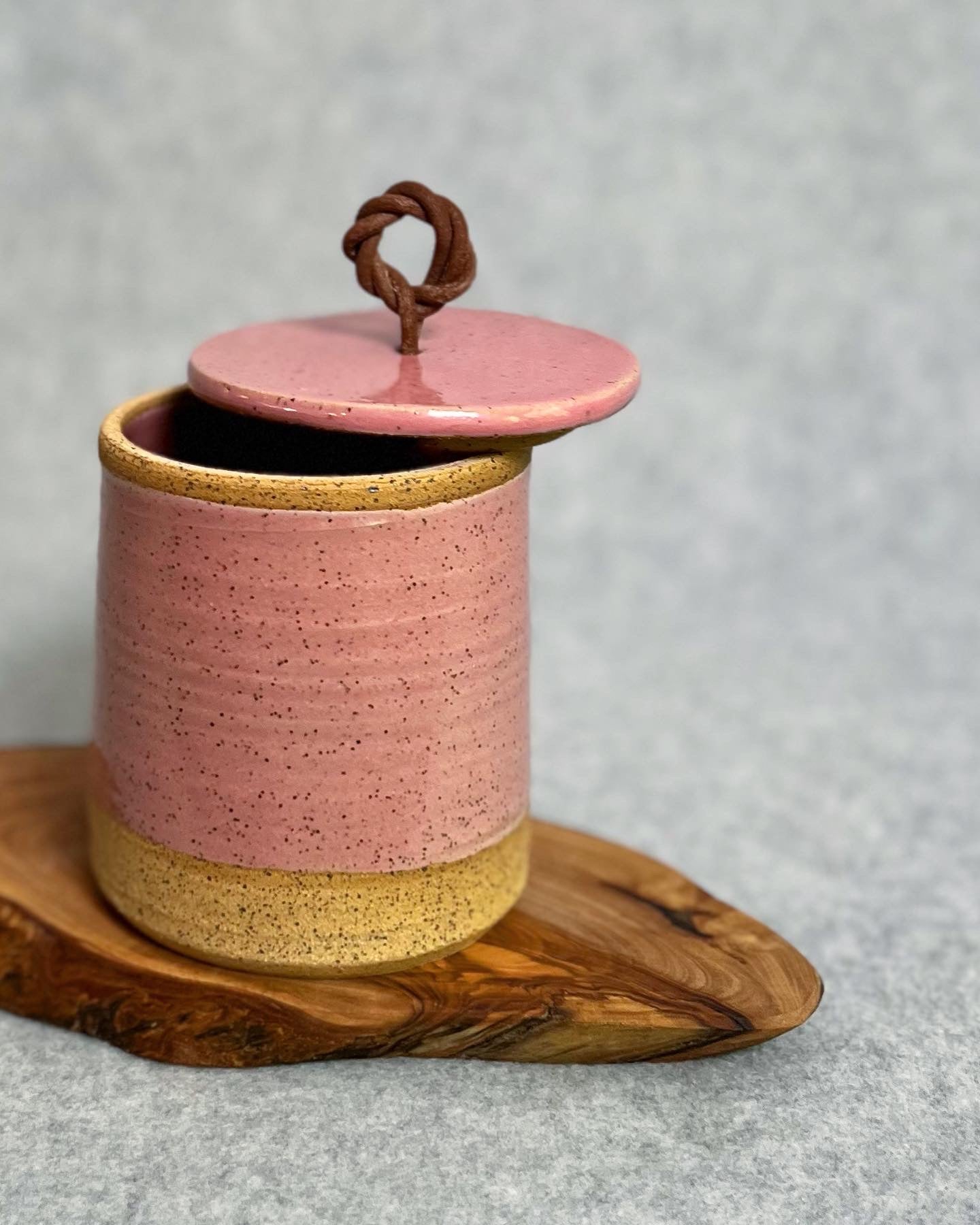 lidded jar with leather handle