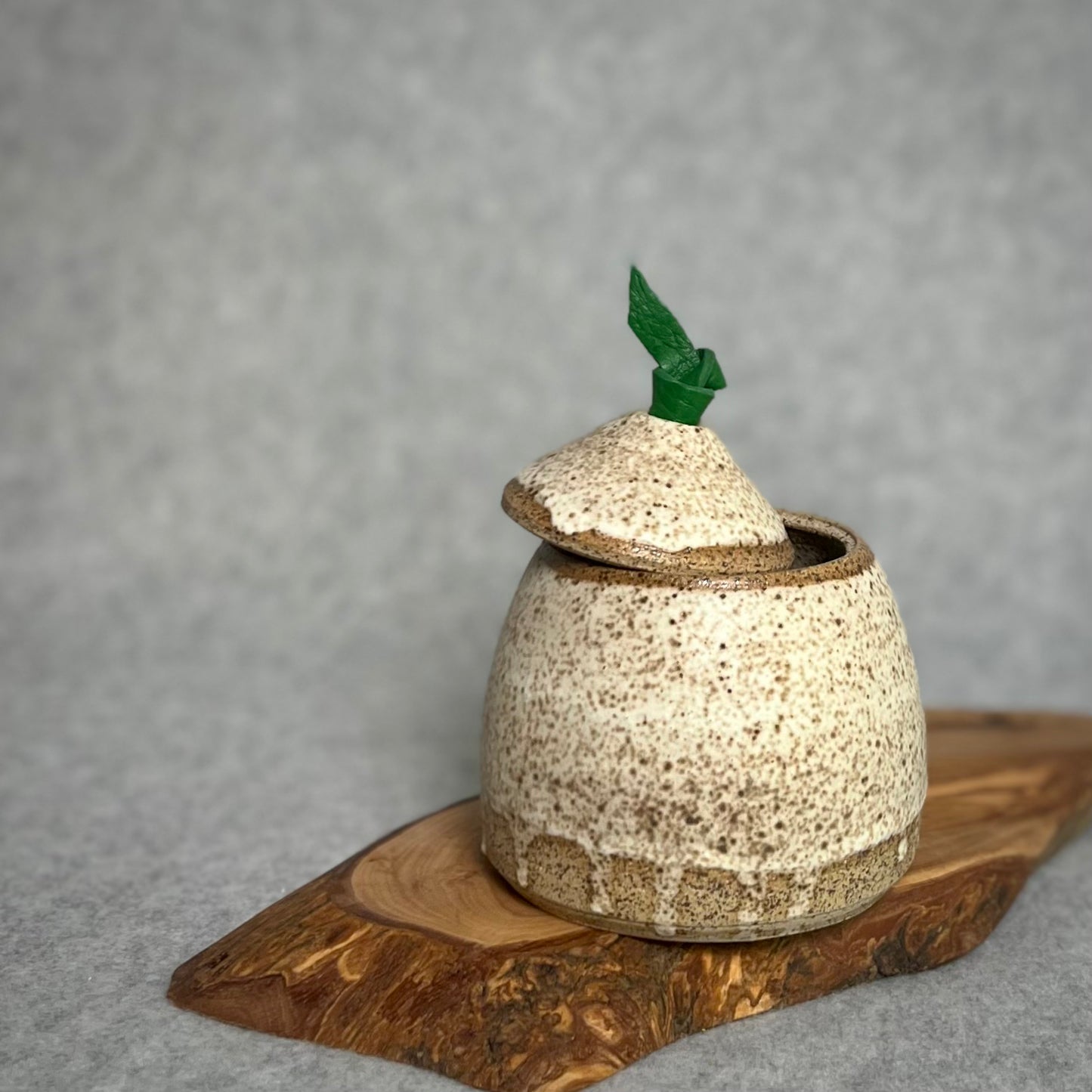 Speckled jar with leather handle