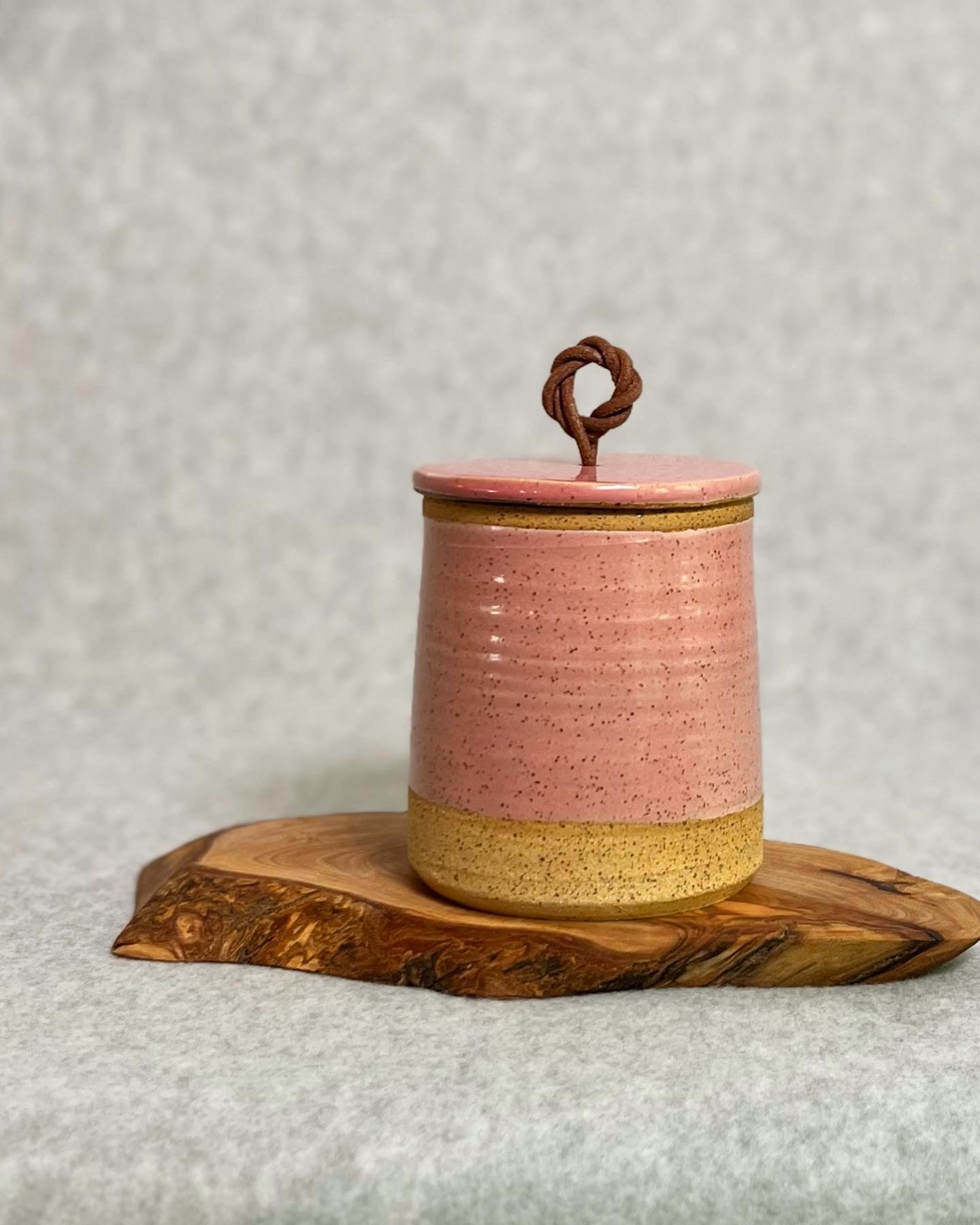lidded jar with leather handle